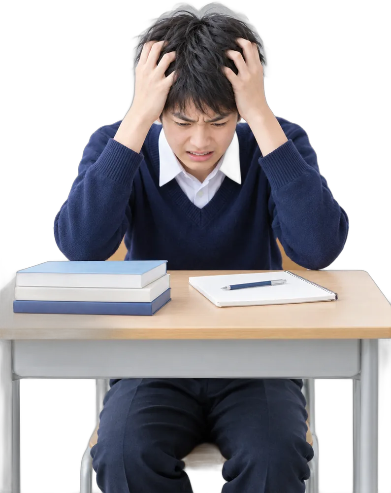机の前で頭を抱える中学生