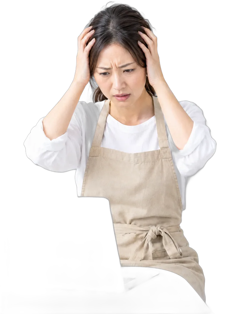 エプロン姿で頭を抱える、開業を考えている女性